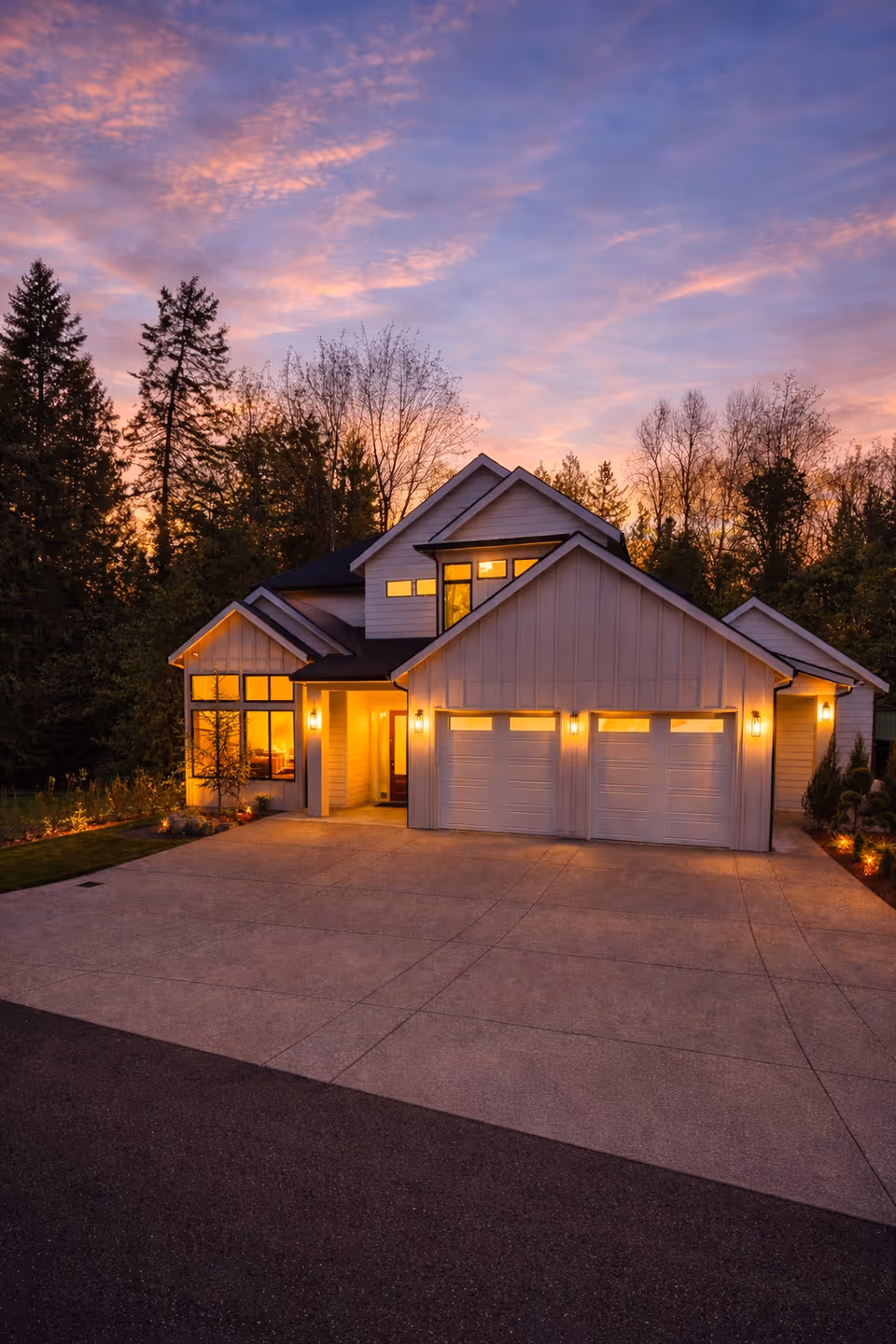 Exterior view of a modern two-story senior care home with a three-car garage at dusk.