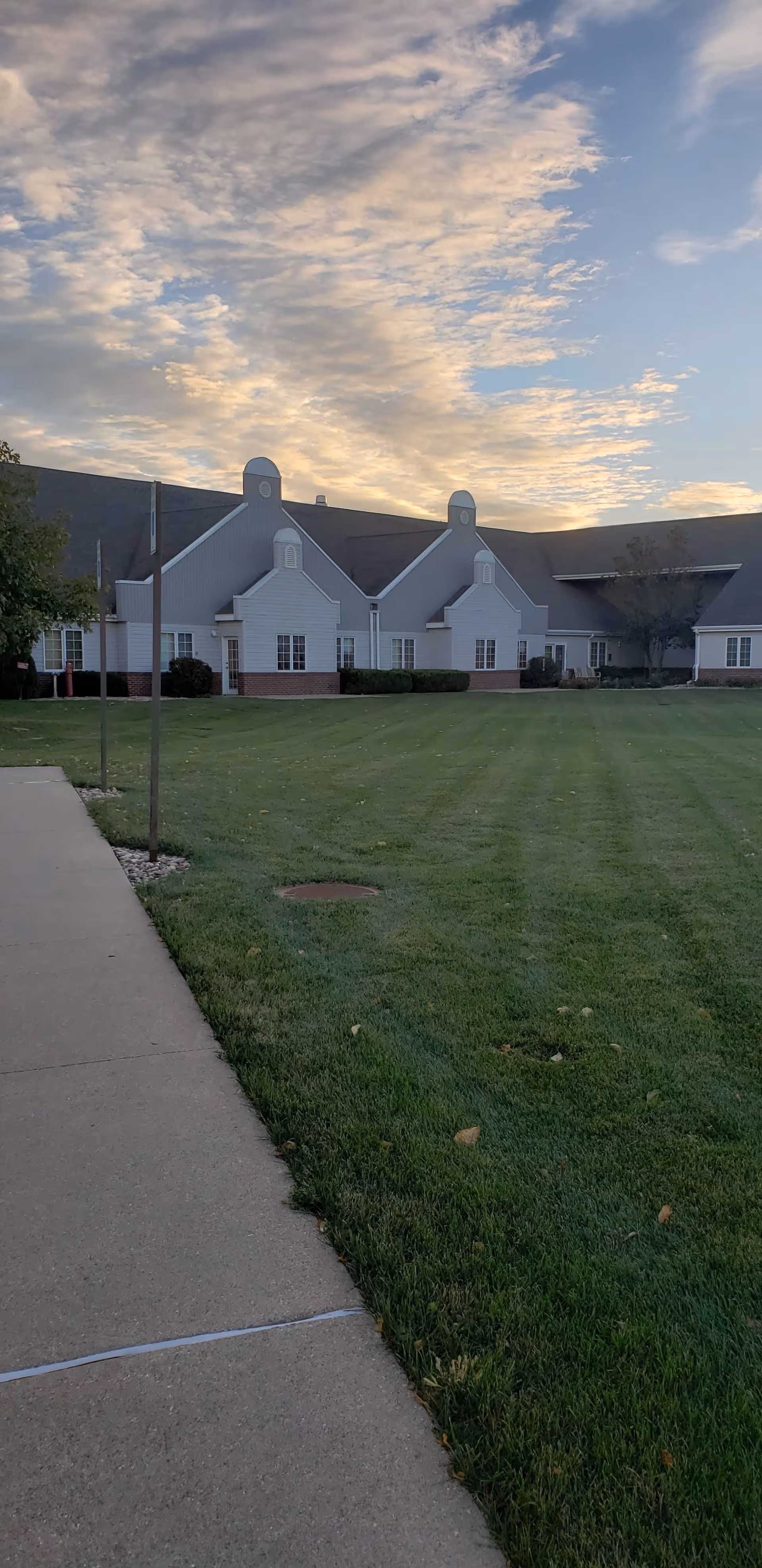 Exterior view of Landsmeer Ridge Retirement Community building with a manicured lawn