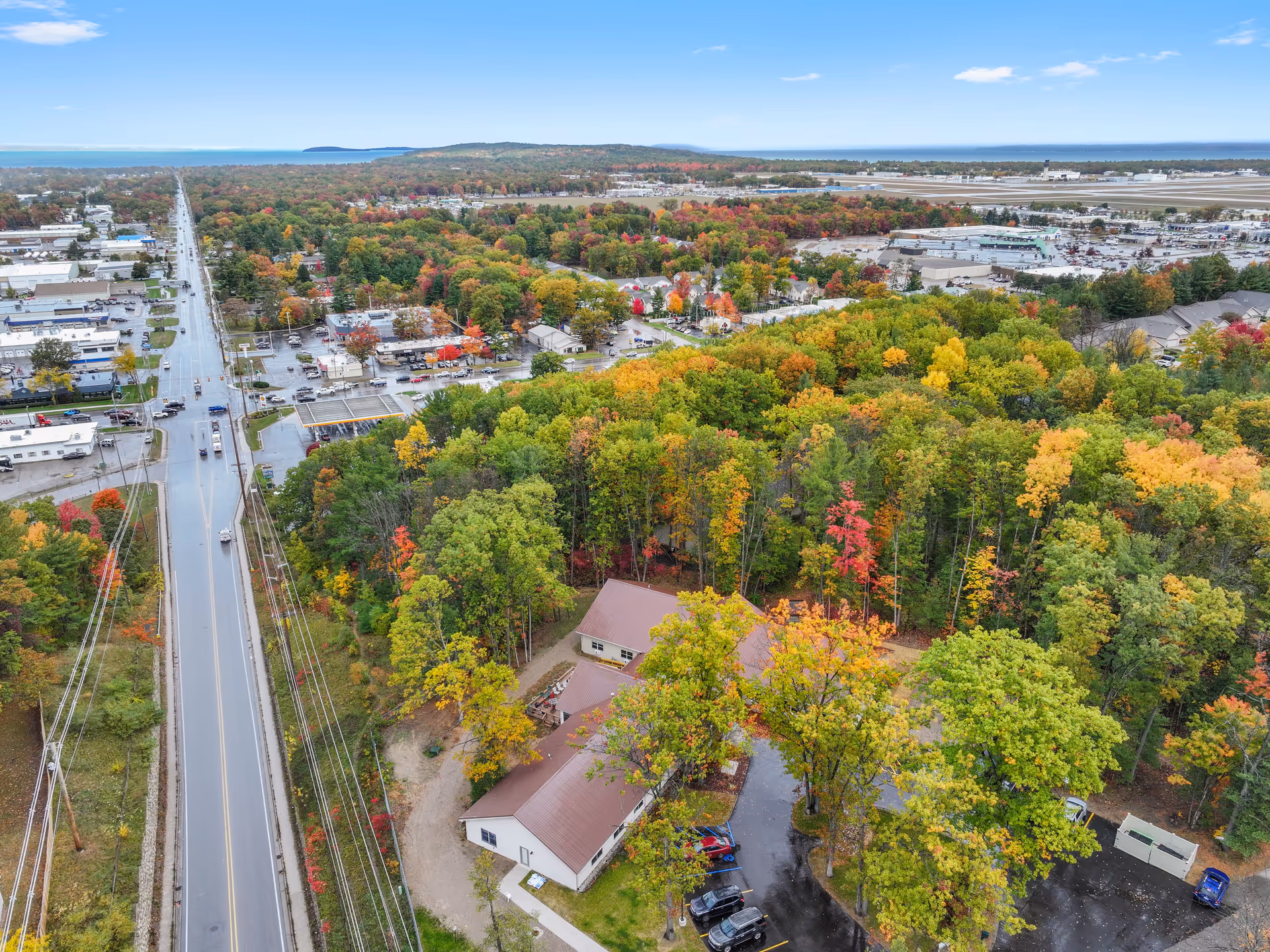 Aerial view of Rosegate Residential Care grounds amid autumn-colored trees and surrounding streets.