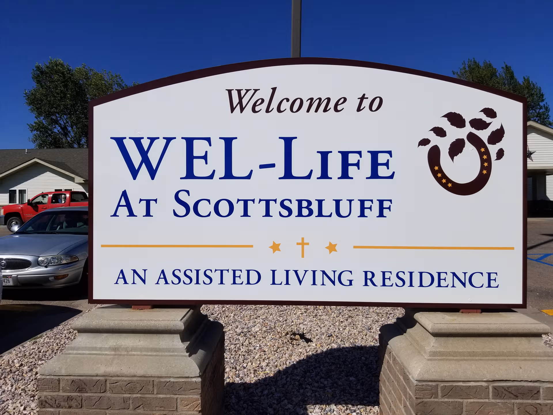 Front sign reading 'Wel-Life at Scottsbluff' outside an assisted living residence.
