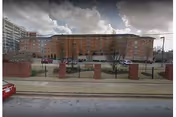 Exterior view of a red-brick senior living building across the street.