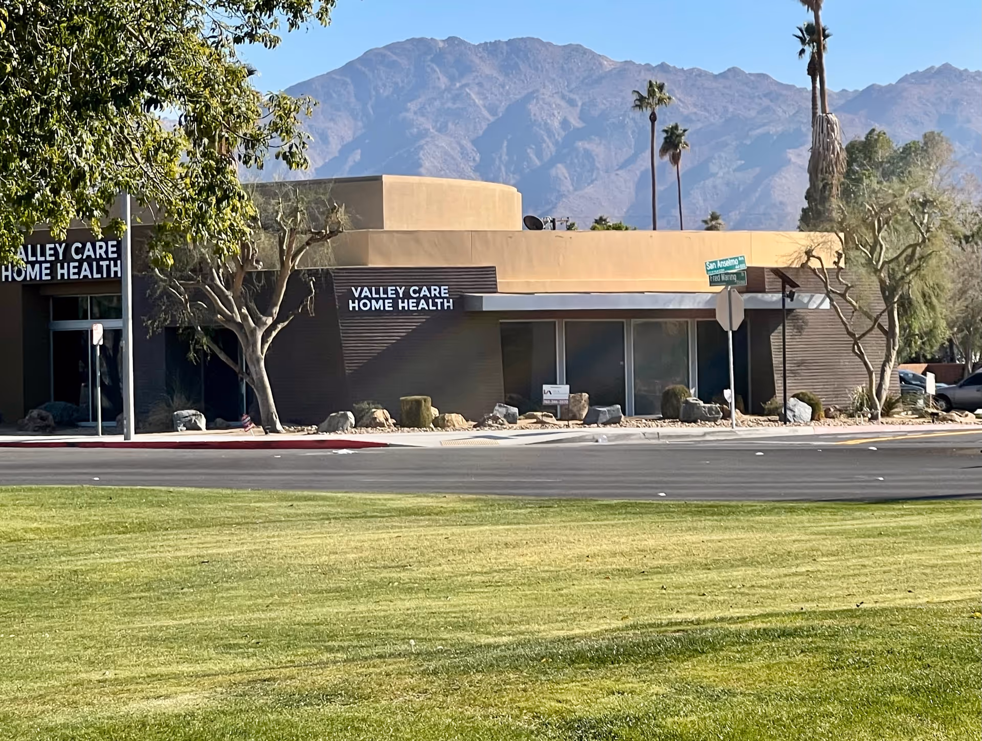 Exterior view of Valley Care Home Health building with mountains in the background.