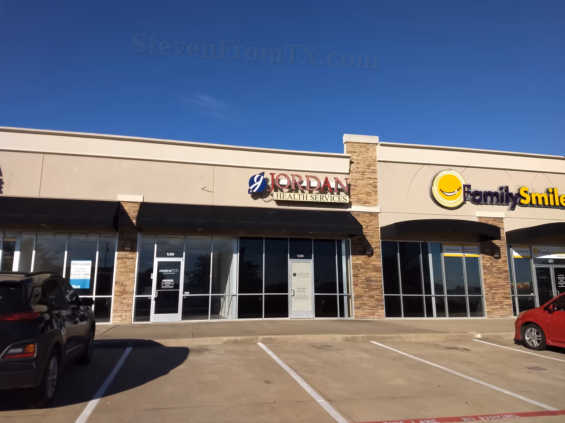 Exterior view of a storefront strip mall showing Jordan Health Services beside FamilySmile.
