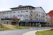Exterior view shows Covenant Village senior living facility with its entrance and landscaping.