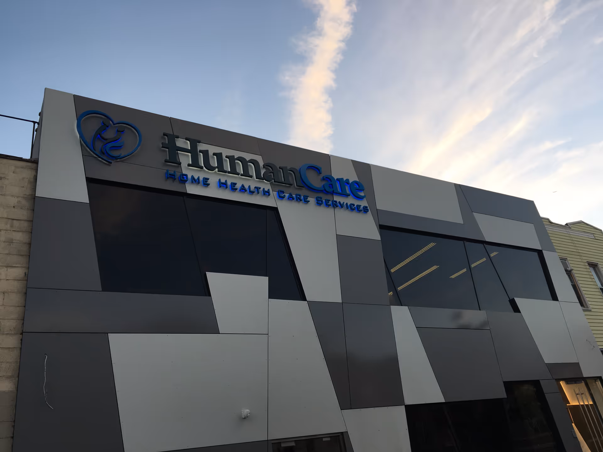 Modern geometric building exterior with a blue HumanCare sign.