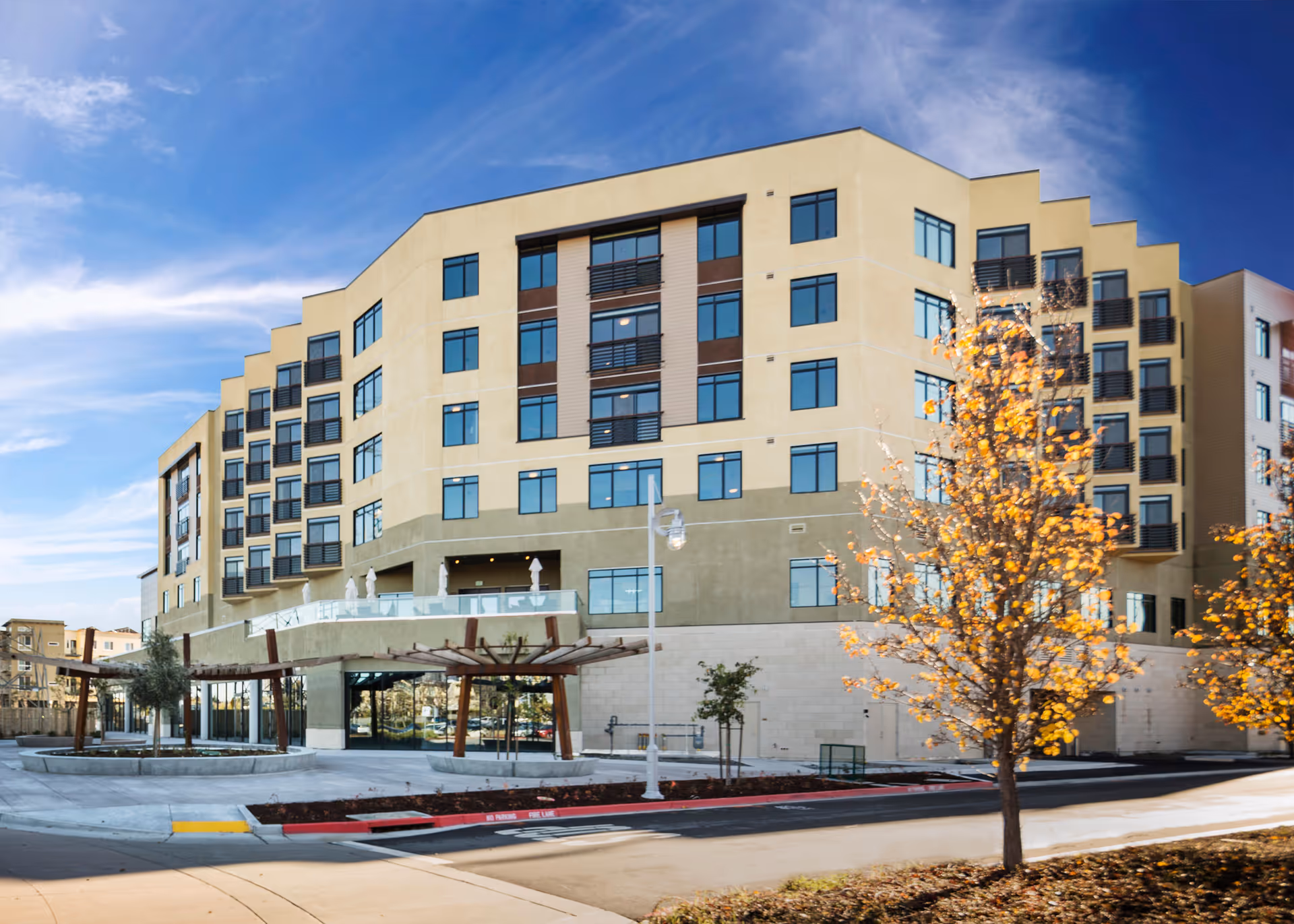 Exterior of Atria at Foster Square, a modern multi-story senior living building.