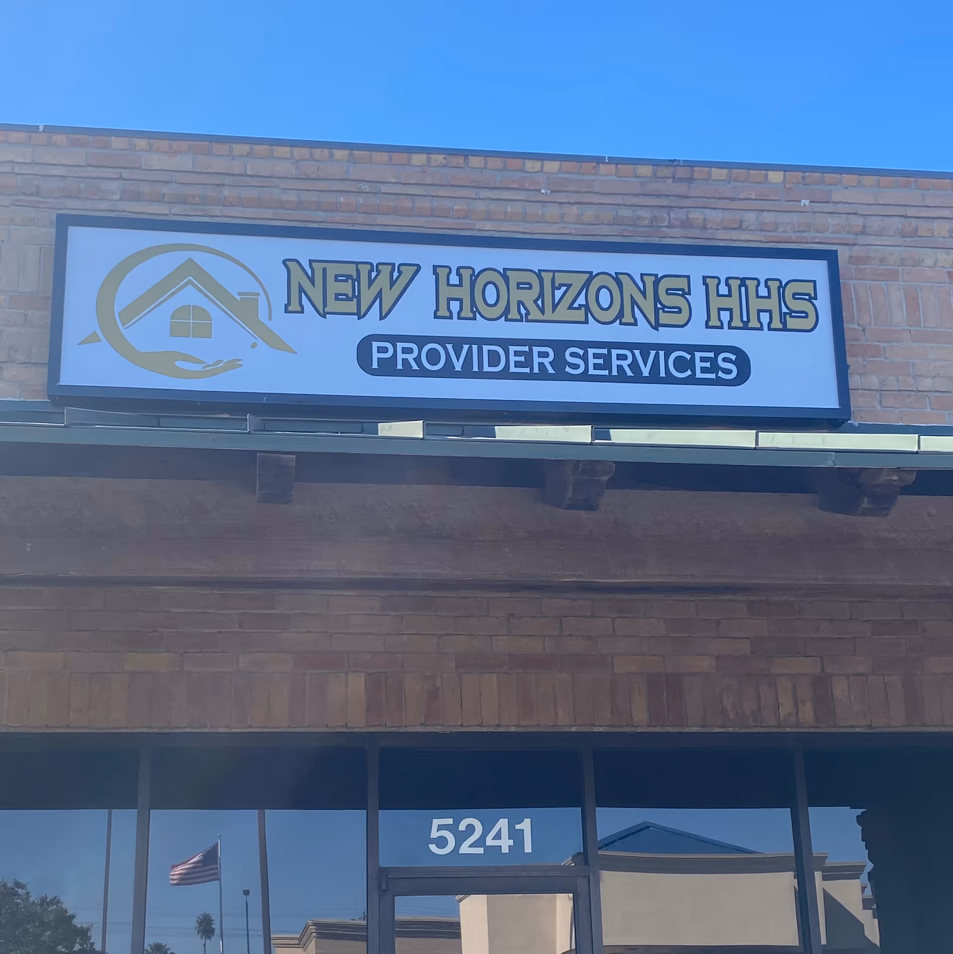 Brick building exterior with a large sign reading New Horizons HHS Provider Services above the entrance.