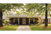 Oakmont Manor senior living front entrance with walkway, porch, and trees