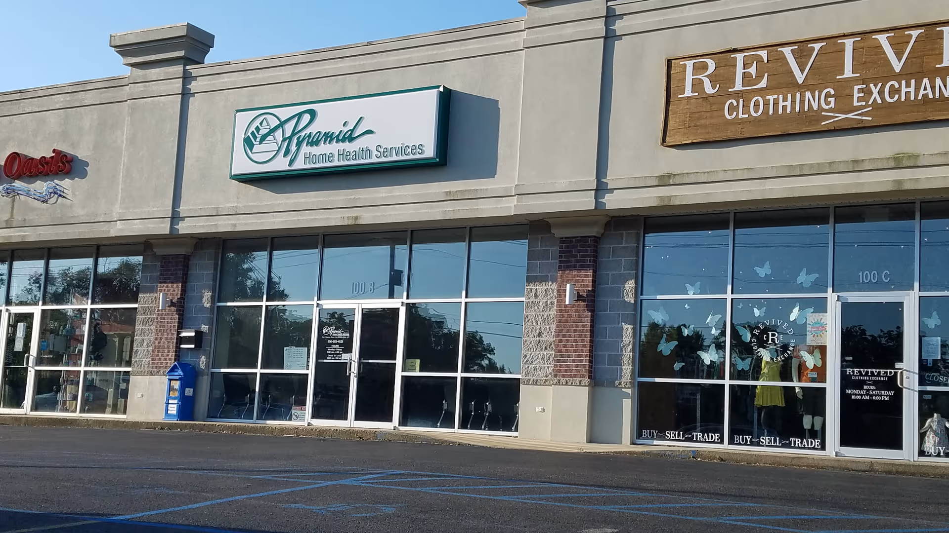Exterior view of a strip mall storefront with Pyramid Home Health Services sign.