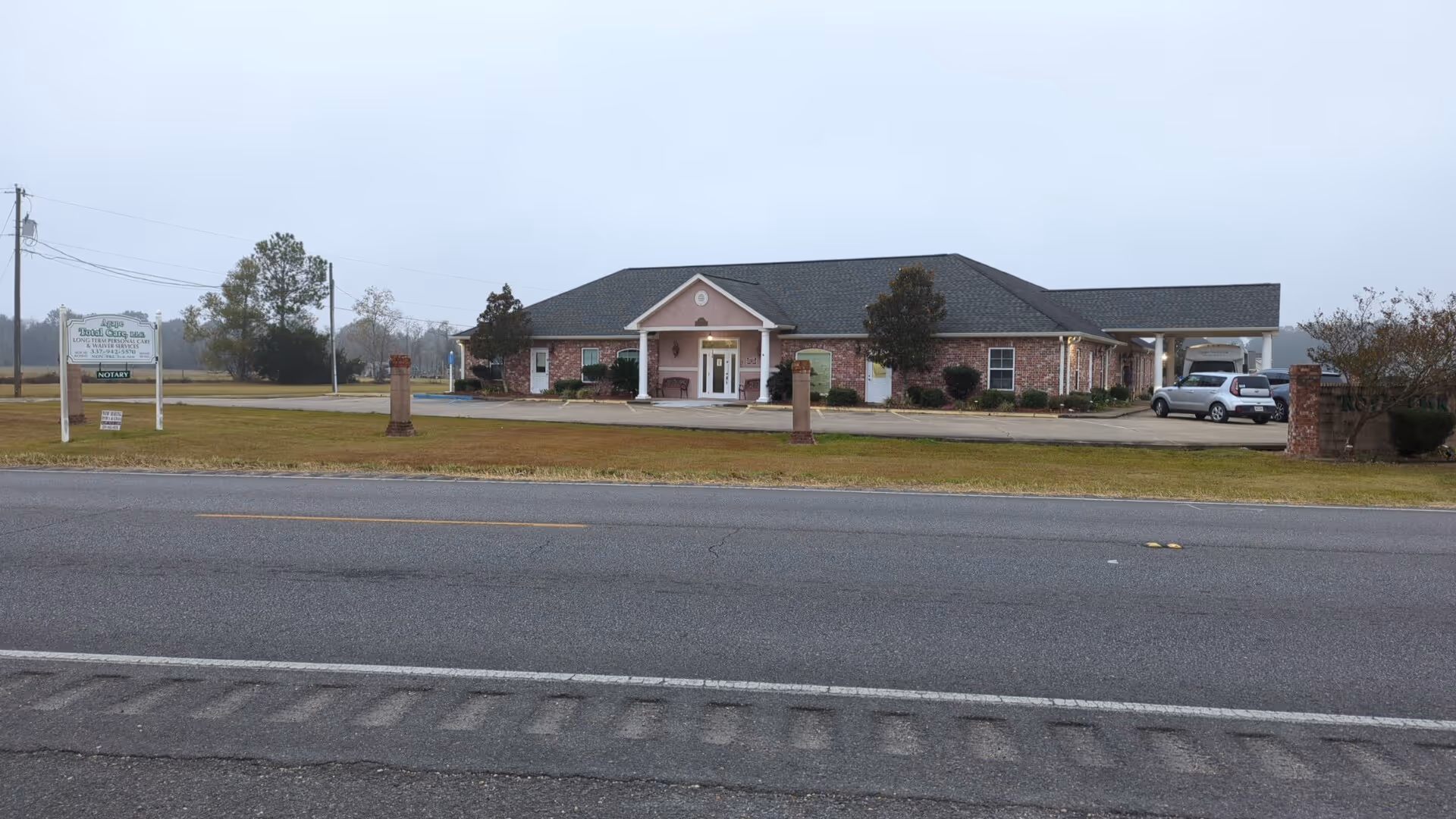 Exterior view of Agape Total Care LLC facility with front entrance and parking.