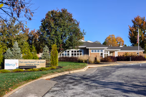 Front exterior of Mercy Hospice - St. Louis de Greeff Hospice House, with a parking lot.