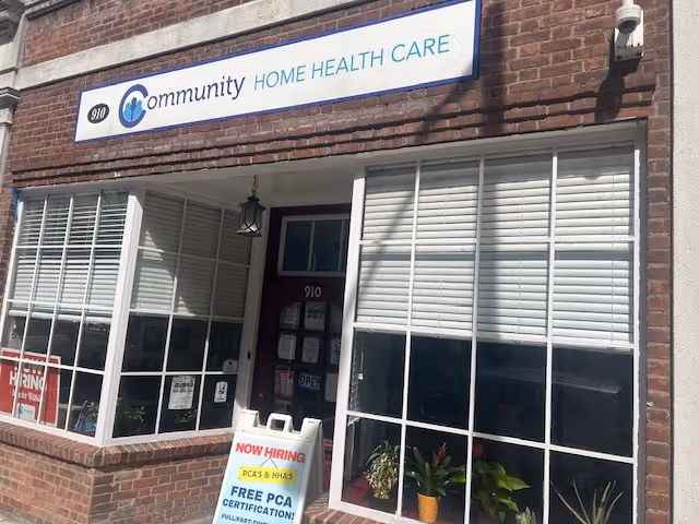 Exterior view of a brick building with large windows and a Community Home Health Care sign.