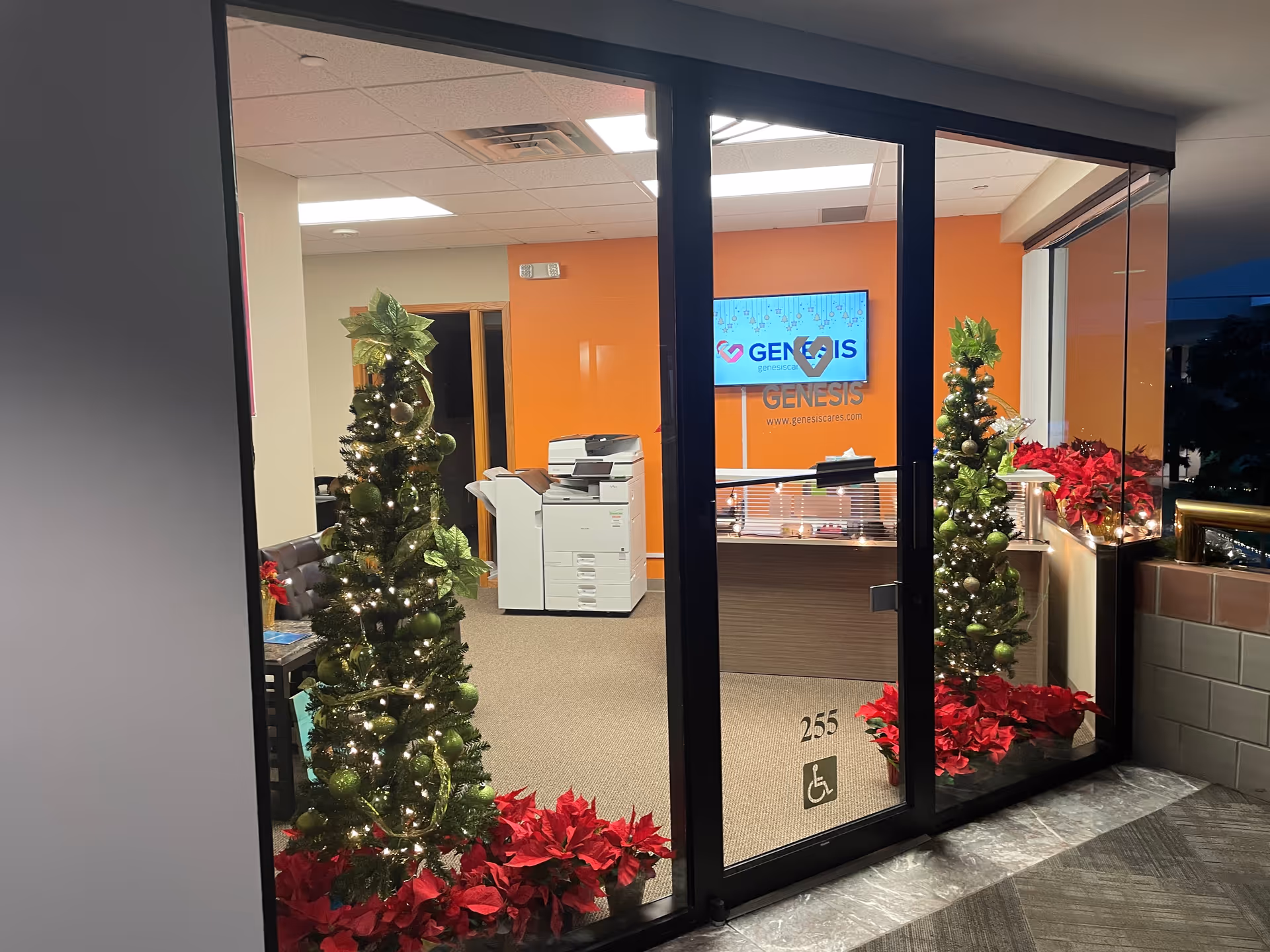 Lobby entrance of Genesis In Home Care with festive trees and front desk.