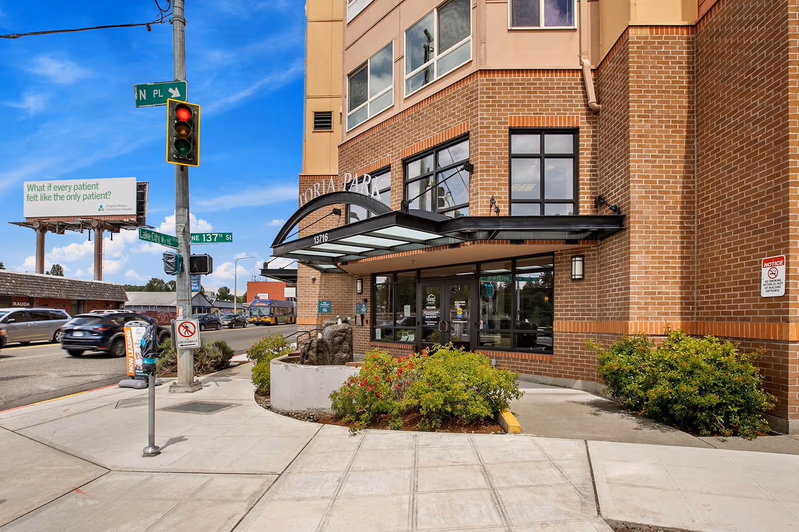 Victoria Park Senior Living entrance with a curved glass canopy and brick exterior