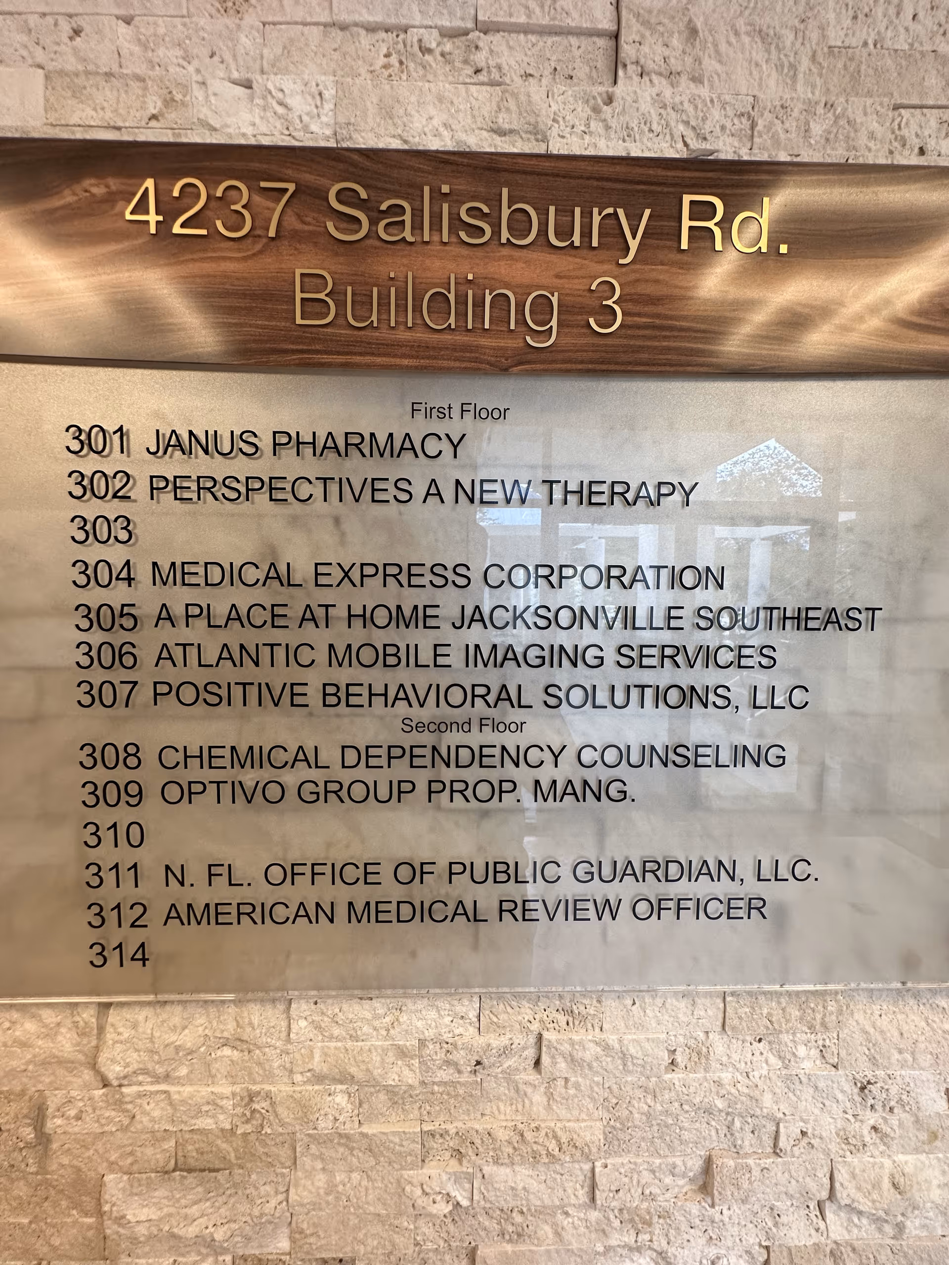 A wall directory plaque lists offices and room numbers at 4237 Salisbury Rd, Building 3 inside.