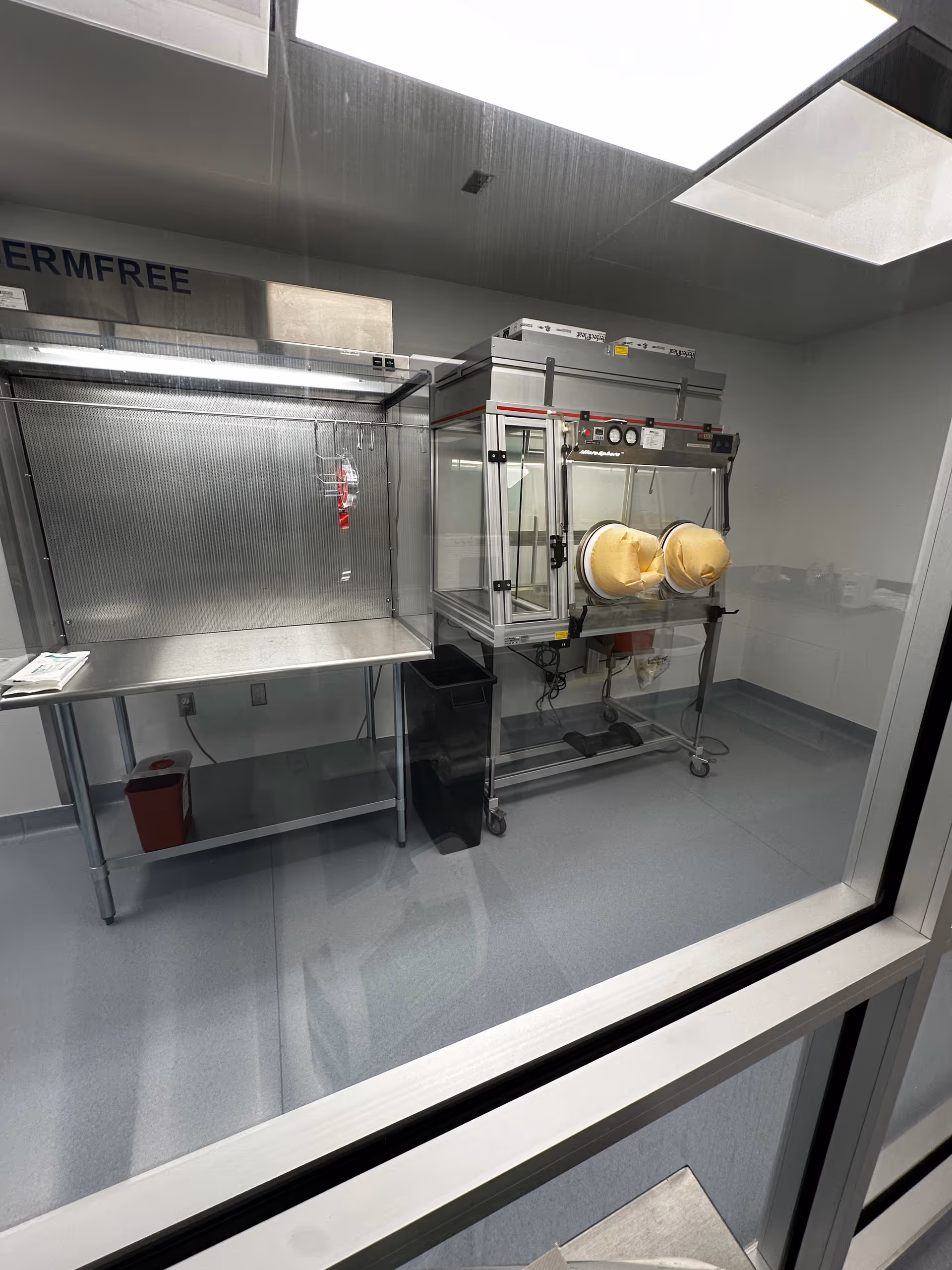 Sterile equipment room with stainless steel table and enclosed sterilization unit.