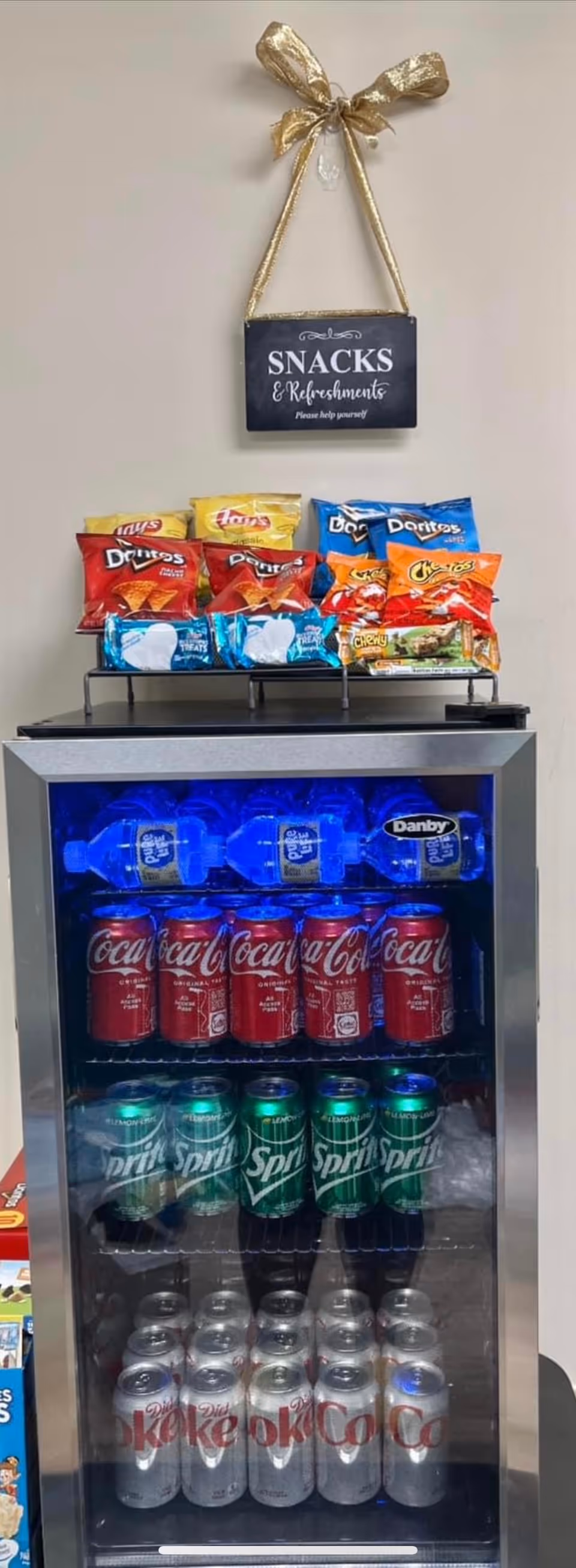 Indoors, a snack and beverage vending fridge stocked with chips and sodas.
