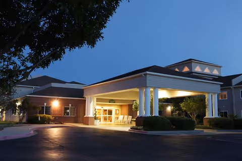 Exterior view of Lyndale San Angelo Senior Living entrance with lit canopy.