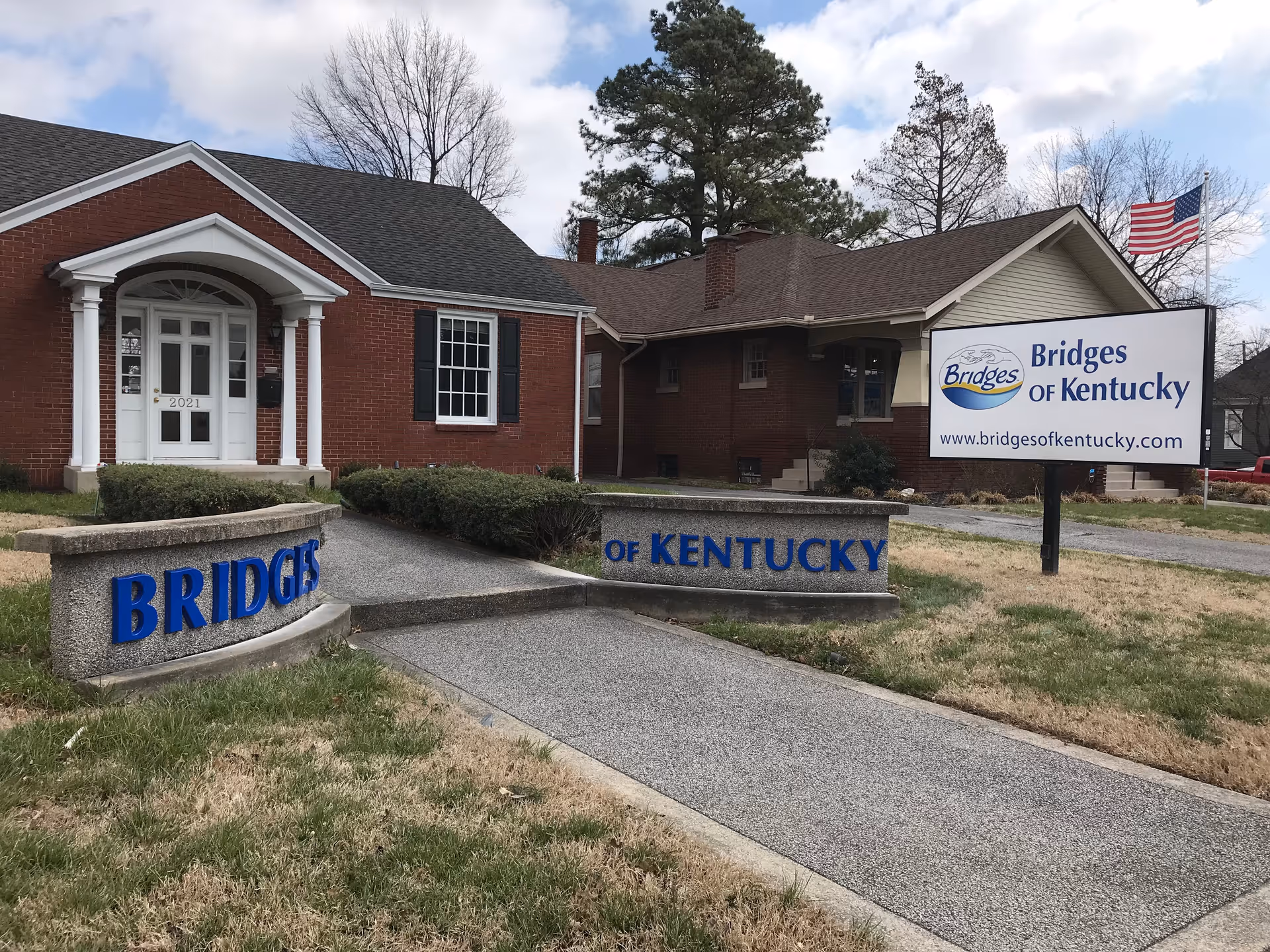 Brick senior living facility with front entrance and Bridges of Kentucky sign.