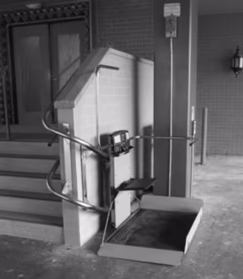 Exterior entrance with a stair lift platform along the stairs.
