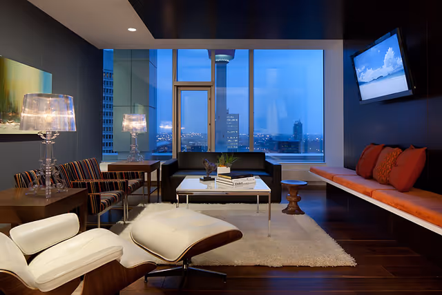 Evening view in a modern senior living lounge with seating and a coffee table.