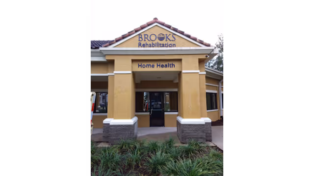 Front view of Brooks Rehabilitation Home Health building with entrance and landscaping.