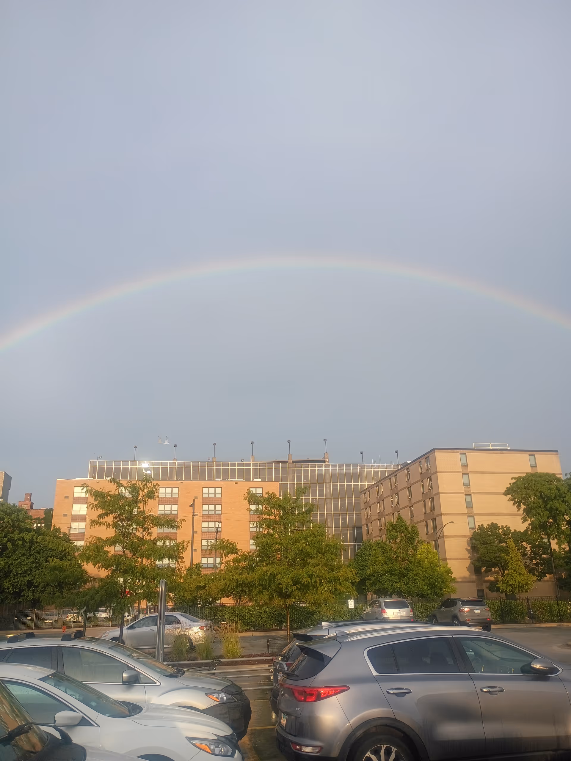 Exterior view of Elevate Care South Holland building with cars and a rainbow.