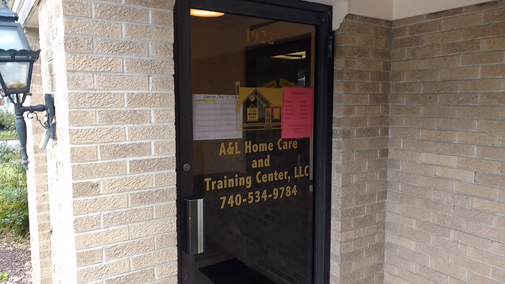 Exterior view of the A&L Home Care entrance on a brick building.