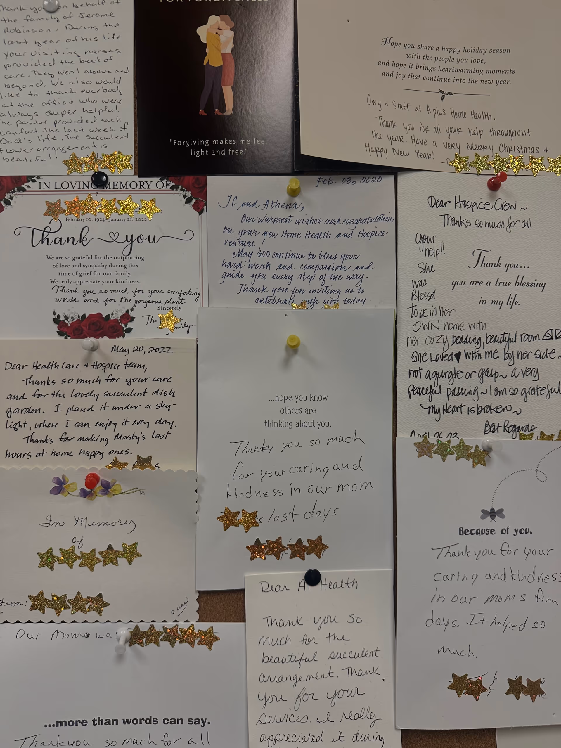 Indoor wall display of handwritten thank-you notes with glitter stars.