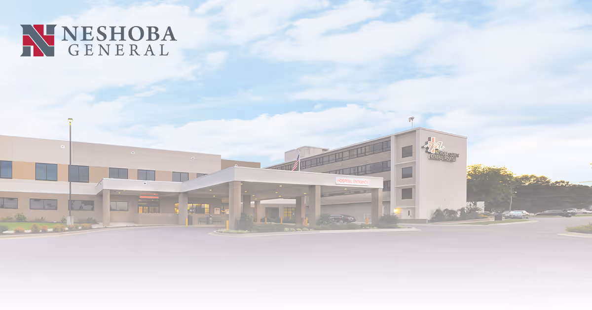 Exterior view of nursing home with front entrance and parking.