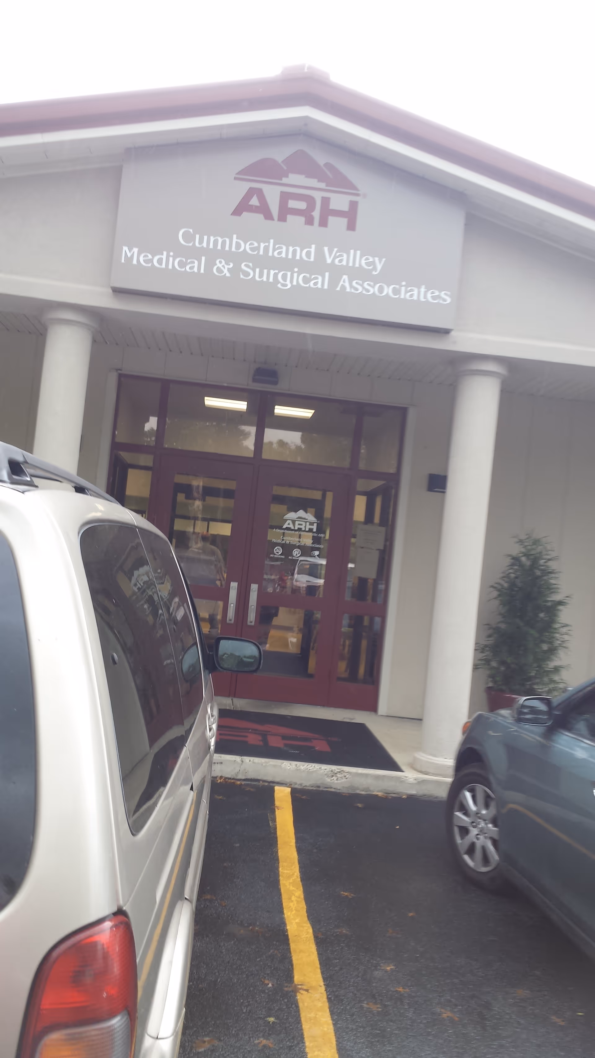Exterior view of ARH Cumberland Valley Medical & Surgical Associates entrance with parked cars.