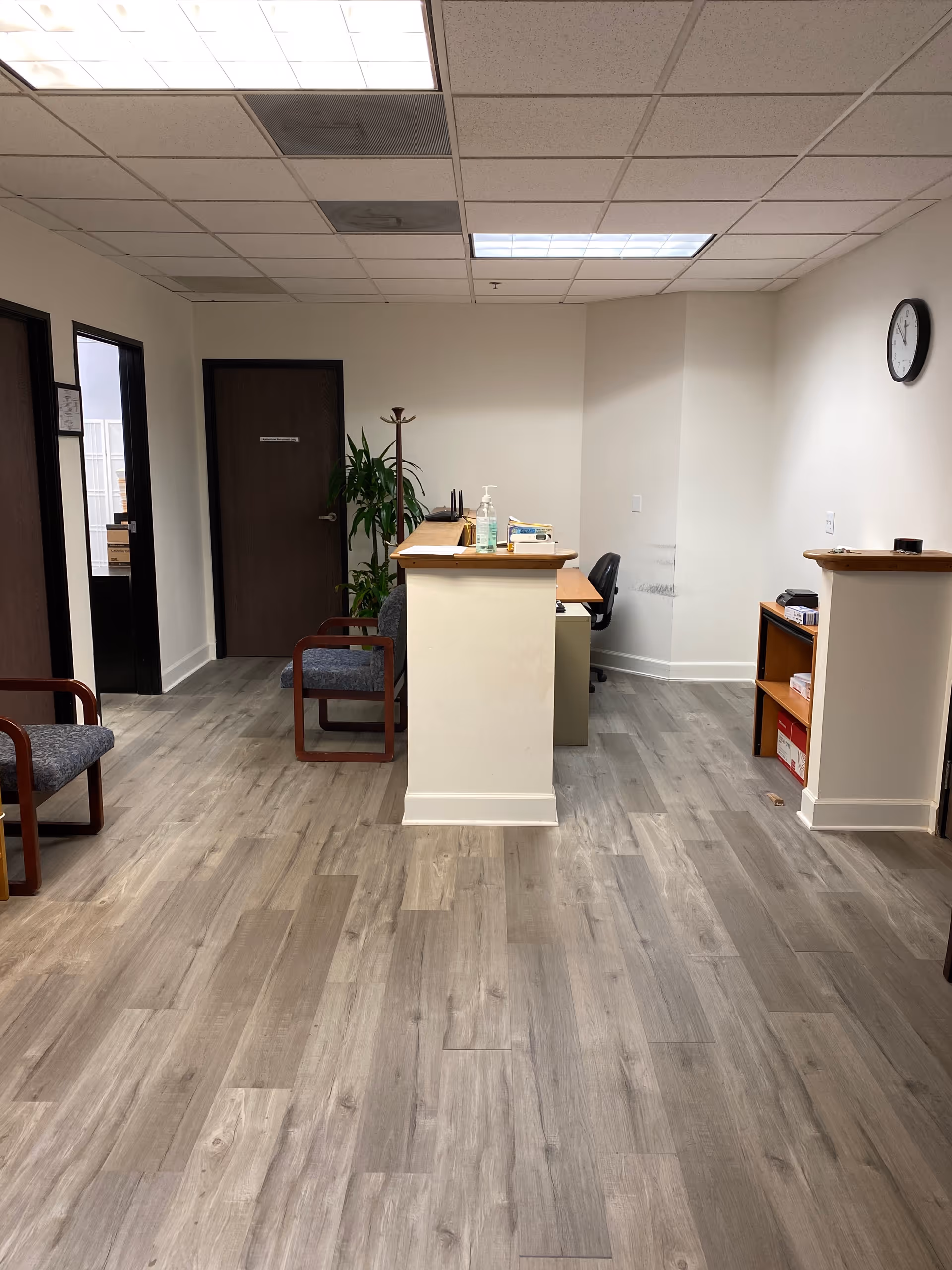 Interior reception area of Glendale Home Health, Inc. with front desk and seating.