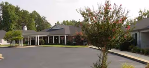 Exterior view of Brookdale Reynolda Road with parking lot, entrance, and landscaping.