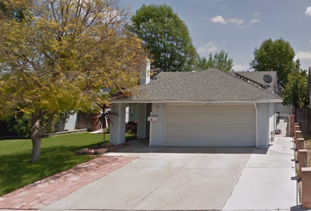 Front exterior view of a single-story facility with a two-car garage and driveway.