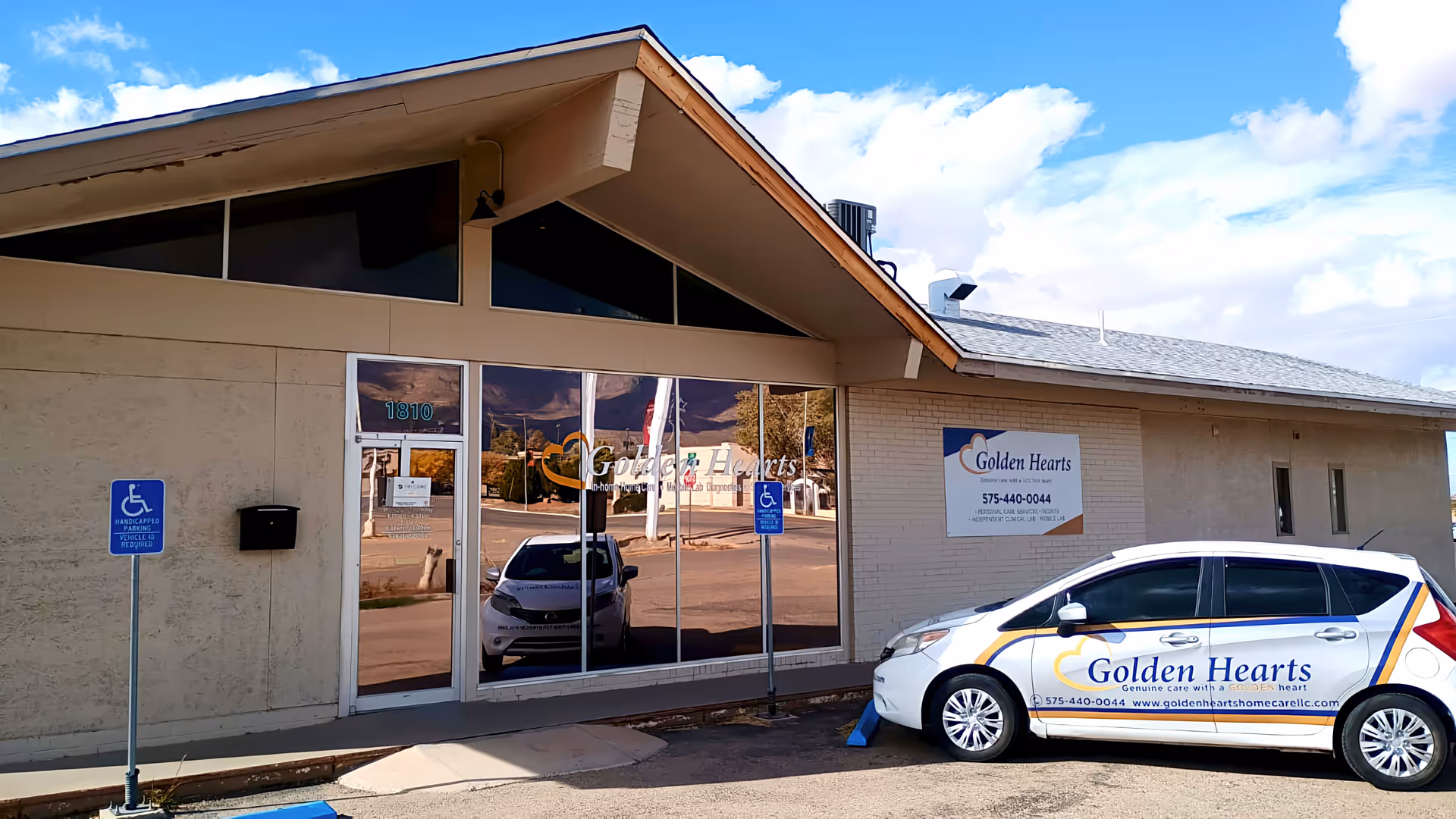 Front exterior of Golden Hearts Home Care building with a logoed car parked outside.