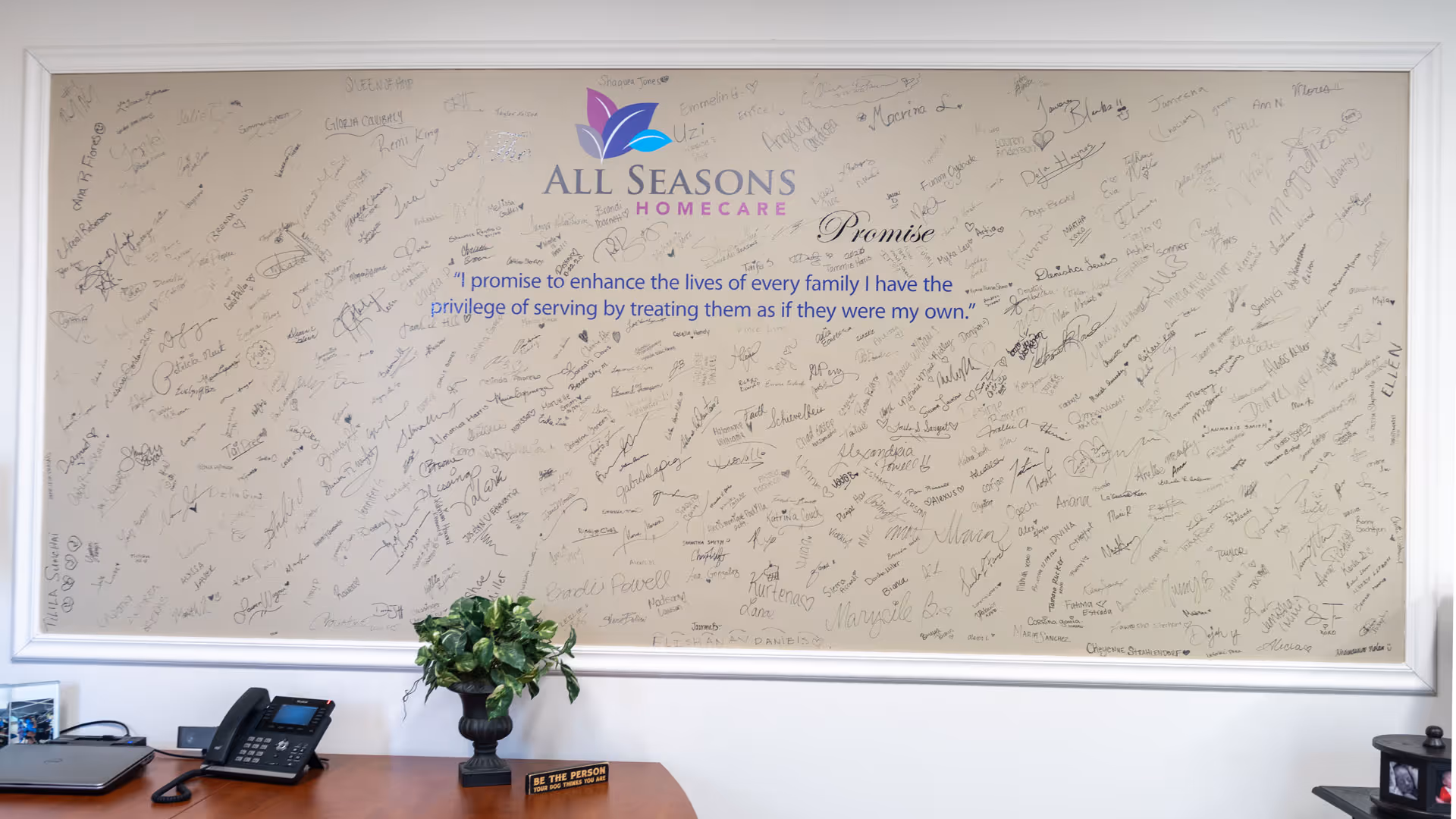Interior office area featuring a wall signed by many with All Seasons Homecare branding.