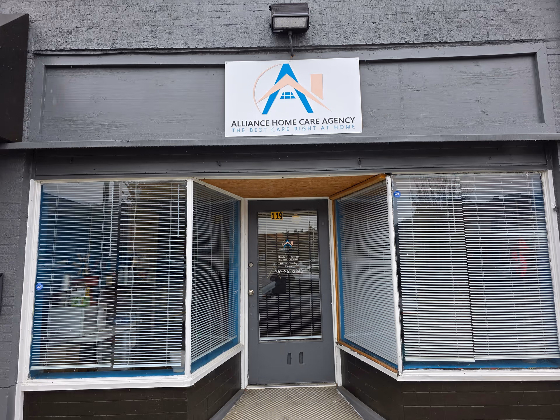 Front entrance of Alliance Home Care Agency with large windows and a central door.