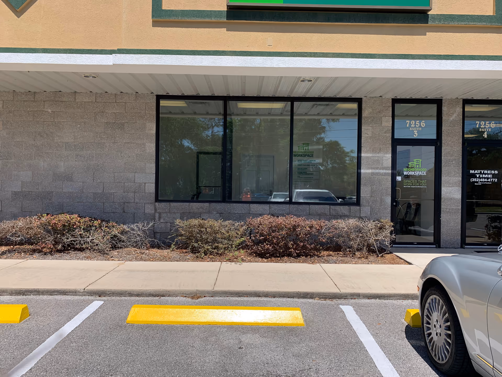 Exterior storefront of Errands Home Health with large windows and a parked car.