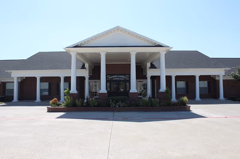 Brick-assisted living facility with white columns and a grand front entrance