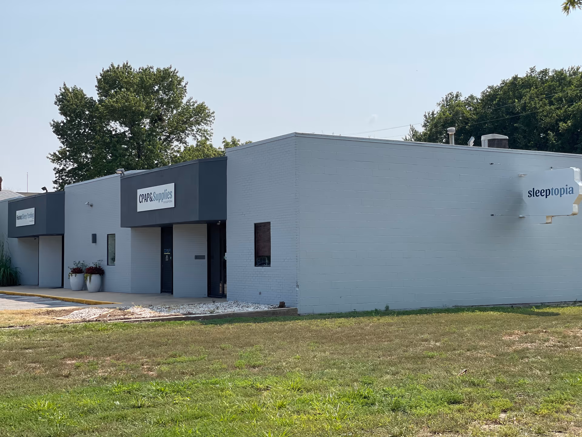 A grey, single-story building with CPAP Supplies and sleeptopia signage.
