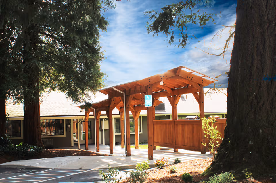 Front exterior of Park Forest Care Center featuring a wooden covered entrance walkway.