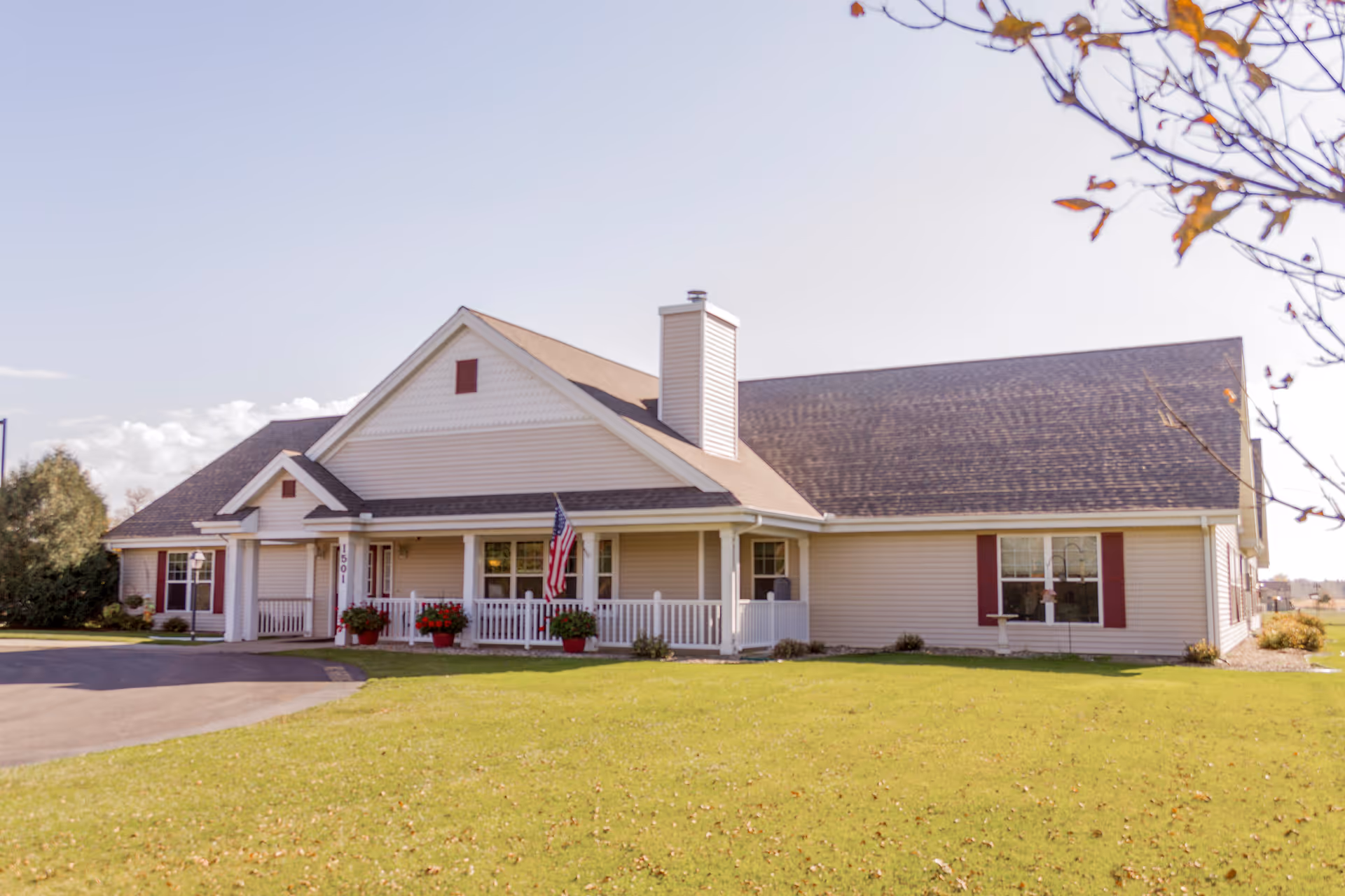 Front exterior of a single-story Brookdale Willmar senior living facility with a porch and flag.