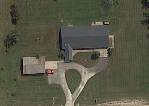 Aerial view of a Gates AFC facility with a curved driveway and surrounding green lawn.