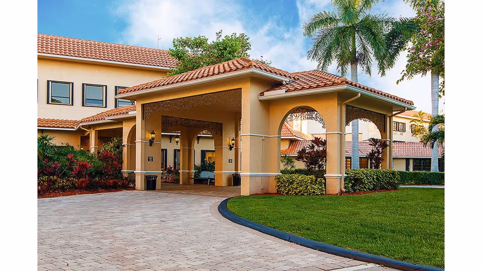 Exterior view of Oakbridge Terrace at Edgewater at Boca Pointe entrance with arches and landscaping