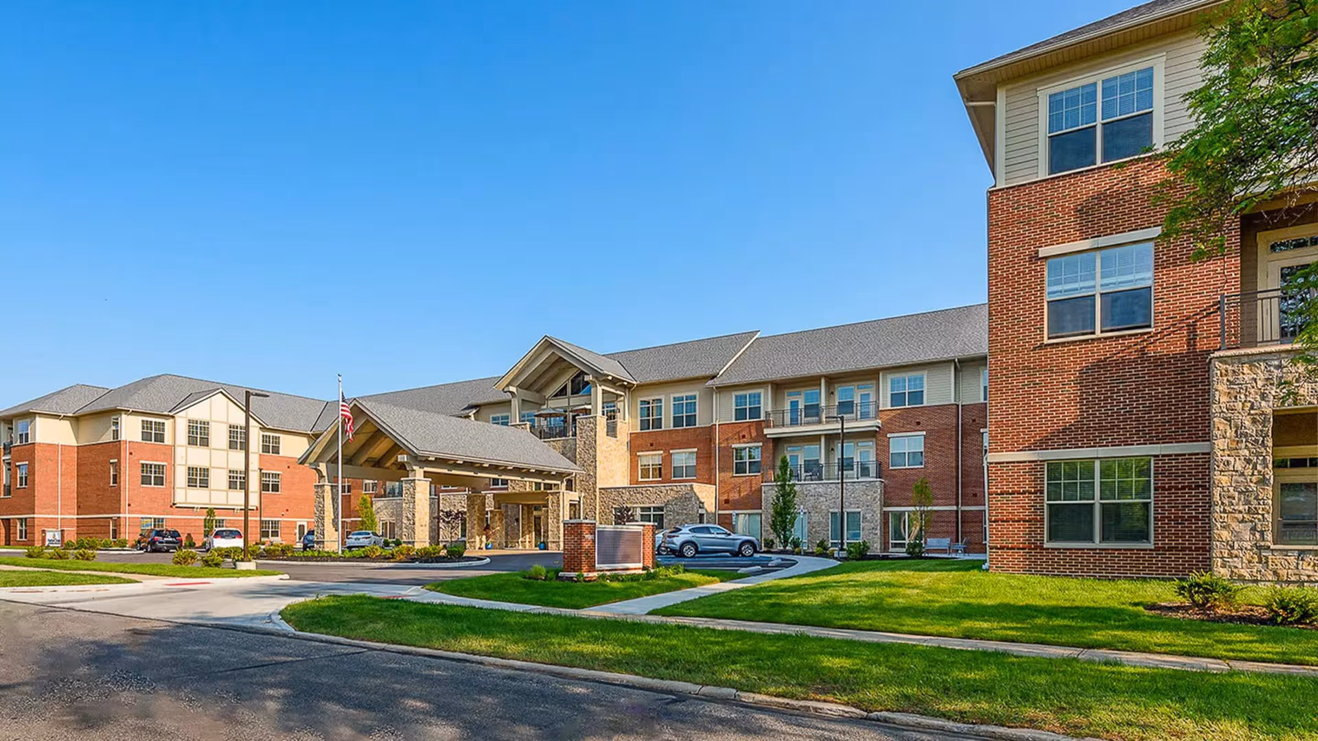 Exterior view of StoryPoint Shaker Heights with brick buildings and a landscaped entrance.