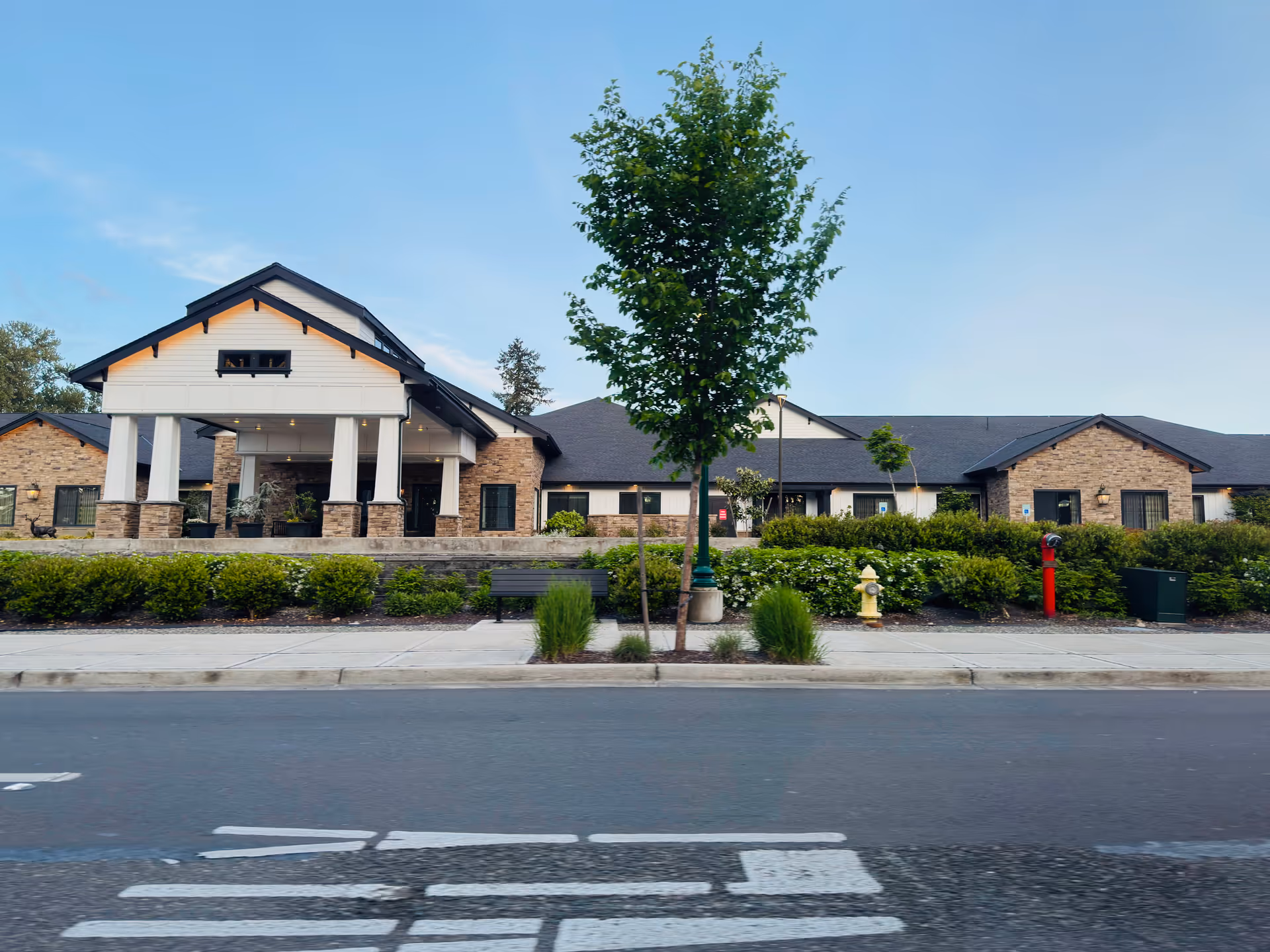 Front view of a single story Deer Ridge Memory Care Community building with a covered entrance.