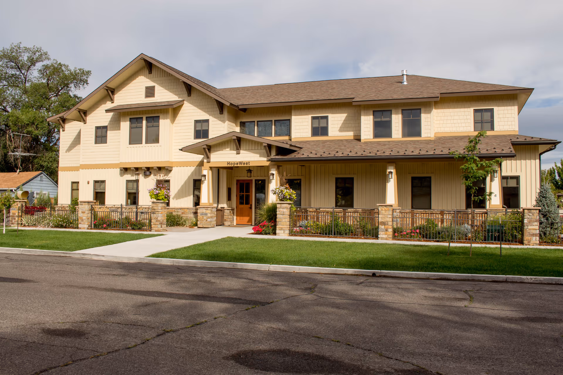 Exterior view of HopeWest Administrative Offices building with entrance, landscaping, and surrounding parking.