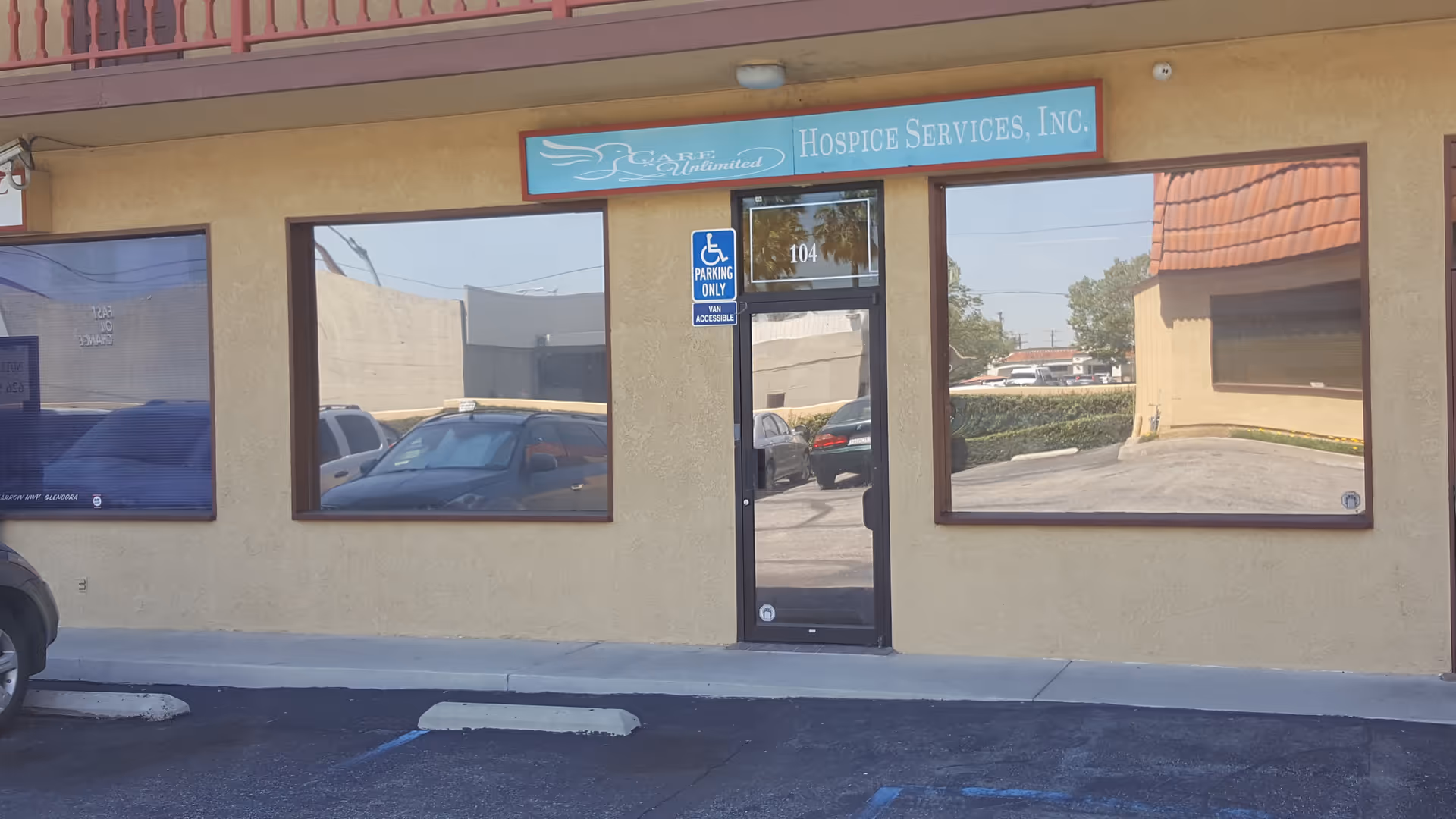 Front view of Care Unlimited Hospice Services storefront with glass door and large windows.