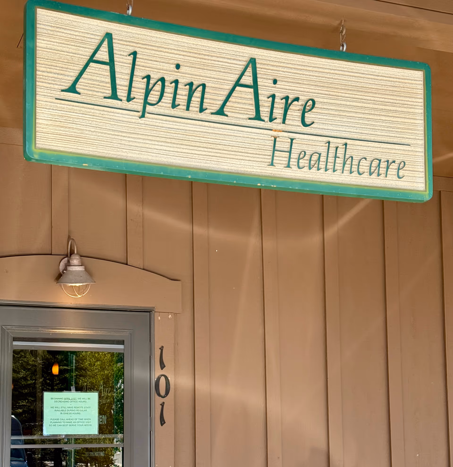 Exterior view of AlpinAire Healthcare building front with its sign.