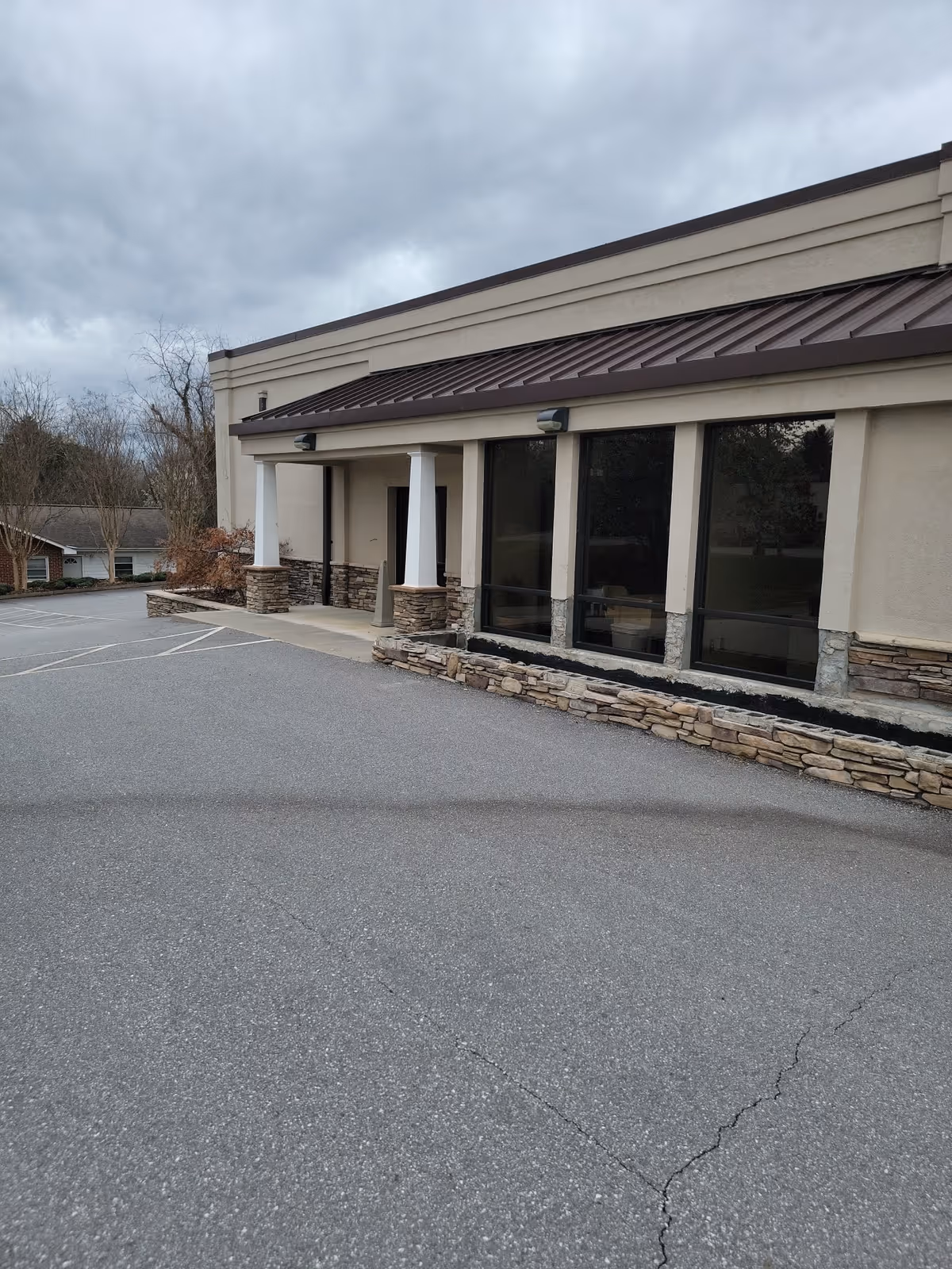 Front exterior of Ashe Home Care, Inc., with large windows and stone accents.